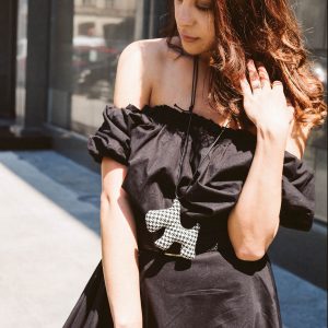 black dress, off shoulder. doggy necklace