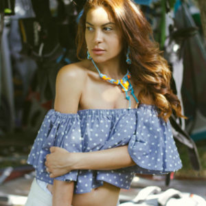 blue off shoulder top in windsurfing club
