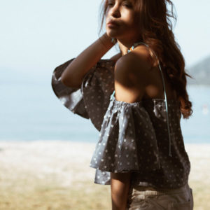 blue off shoulder top on the beach